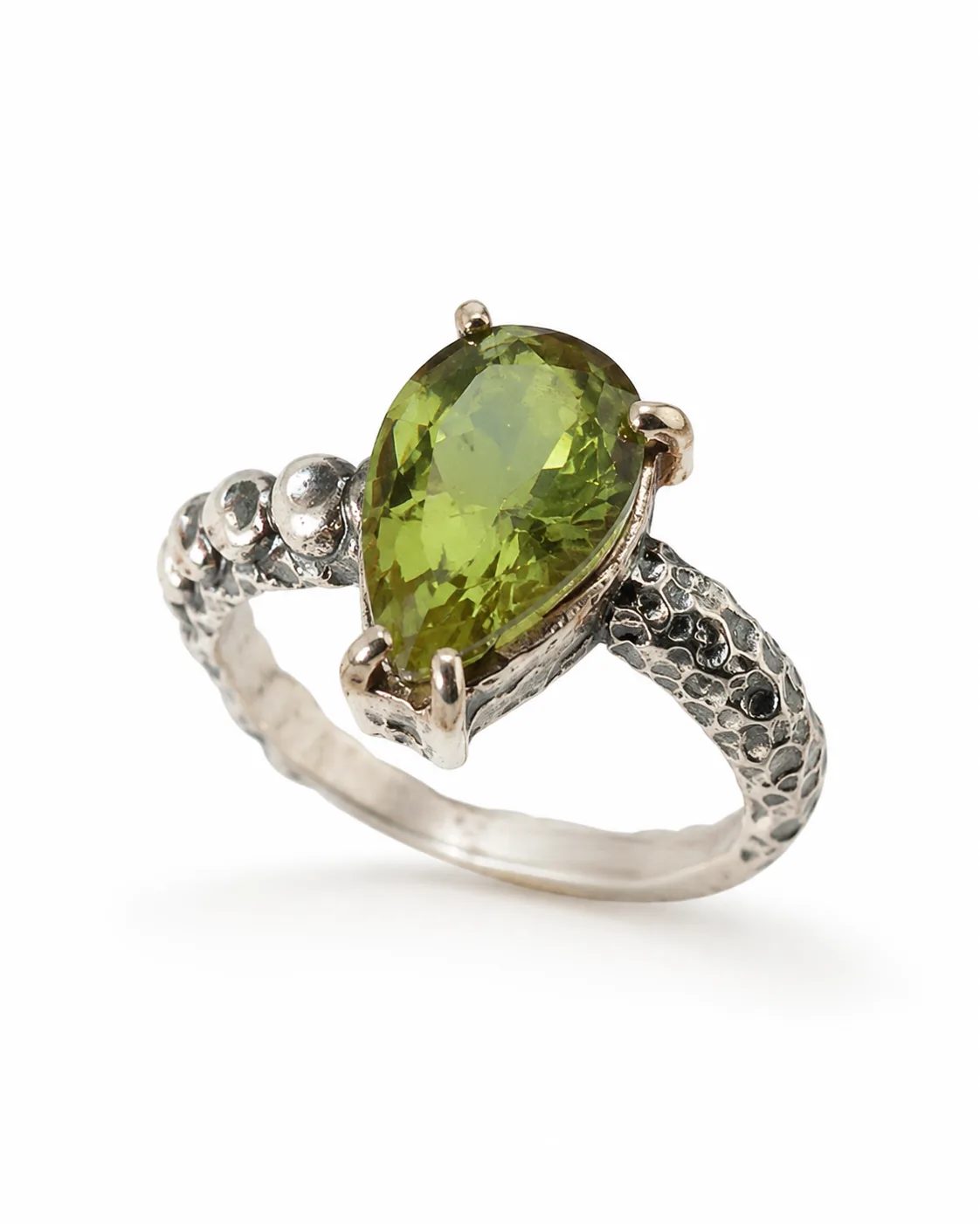 Pear-cut zultanite sterling silver ring with a large faceted green gemstone, hammered band and oxidized artisan details
