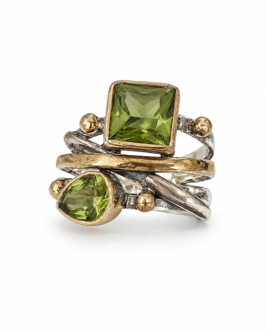 Dual zultanite mixed metal wrap ring with square and pear-shaped green gemstones on a white background