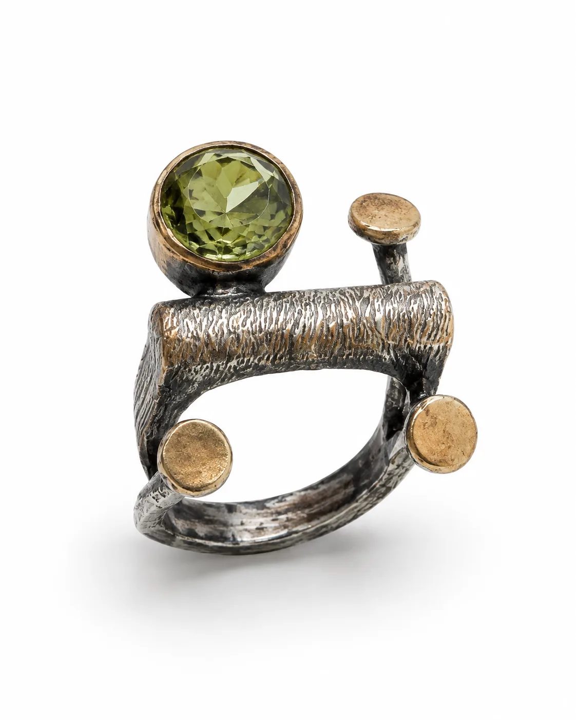 Architectural zultanite sterling silver ring with a round green gemstone, bronze accents and textured oxidized openwork on a white background